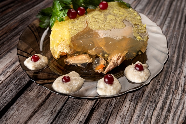 homemade jelly meat with horseradish sauce on a wooden table 1 - Холодец