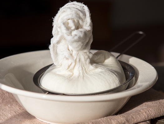 preparation of cottage cheese woman straining the milk through a cheesecloth - Царская пасха без творога с лимонным соком