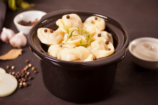 homemade russian pelmeni meat dumplings italian ravioli in the small black pan - Пельмени с грибами по-монастырски