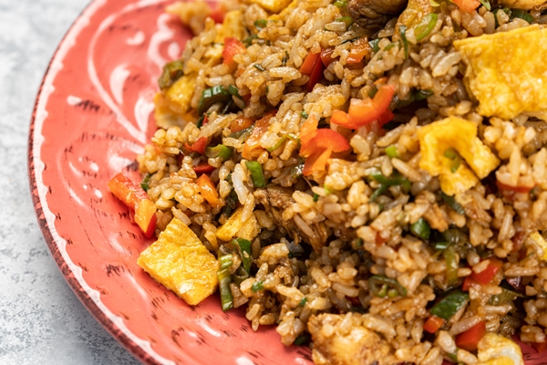 closeup of delicious cooked rice with vegetables and sauce in a plate on the table - Постные ленивые голубцы с грибами и рисом