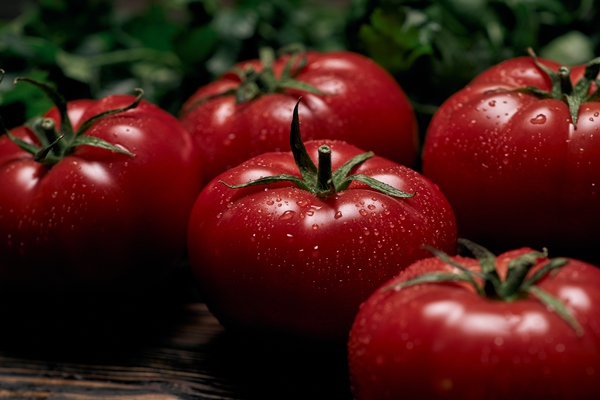 large juicy tomatoes on a wooden board - Острая закуска из кабачков "Тёщин язык"