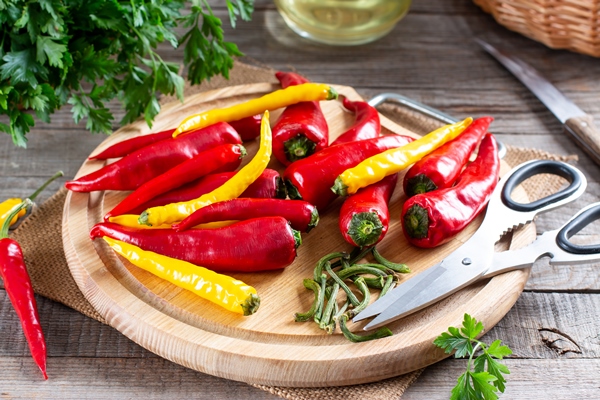 chili pepper preparation before freezing on a wooden board on the table frozen food frozen vegetables - Закуска овощная "Огонёк"