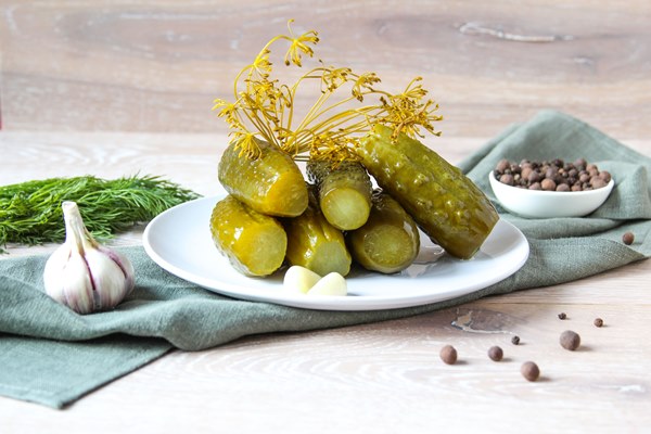 plate of pickled homemade cucumbers on wooden rustic background marinated pickled cucumbers - Салат мясной с солёными огурцами