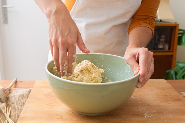 baker in apron kneading dough for tasty pastry and bread - Хлеб из цельнозерновой муки