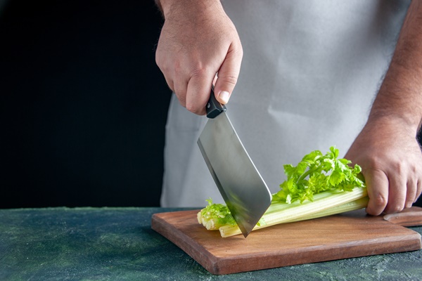 front view male cook cutting celery on dark wall health diet meal color photo food - Смузи-боул из брокколи