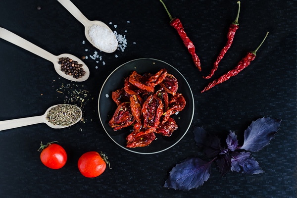 homemade sun dried red tomato slices with olive oil sea salt basil and oregano spices on dark background cooking process traditional italian mediterranean cuisine top view flat lay - Постные голубцы с картофельным пюре