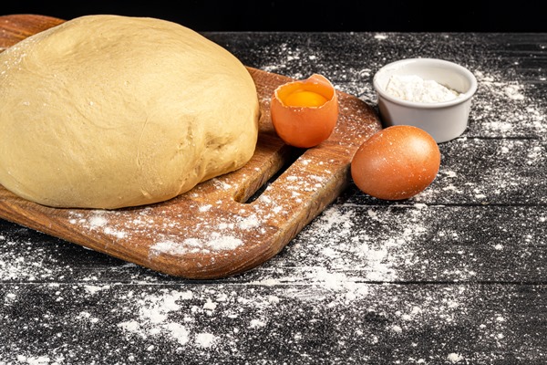 dough preparation yeast dough for pies rolling pin with flour on a dark background - Свадебный каравай