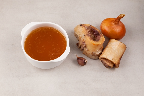 homemade boiled beef bone broth golden meat bouillon bones contain collagen - Бульон красный со слоёными мясными пирожками