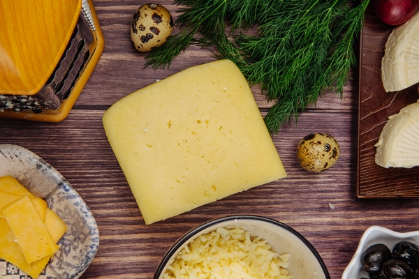 top view of dutch cheese with quail eggs dill and grated cheese in a bowl on rustic wood - Пицца "Сицилийская"