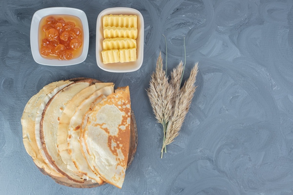 wheat stalks pancakes white cherry jam and butter on marble table - Блинцы яичные простые на воде