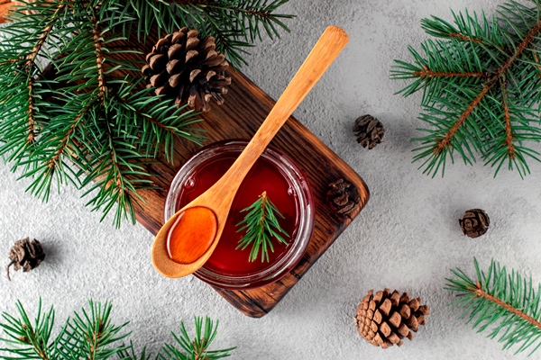 jam of young pine cones with pinecones on wooden board 1 - Еловое варенье из побегов