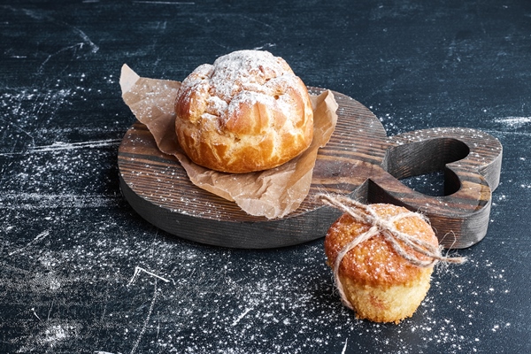 puff pastry bun with cupcake on a wooden board - width=