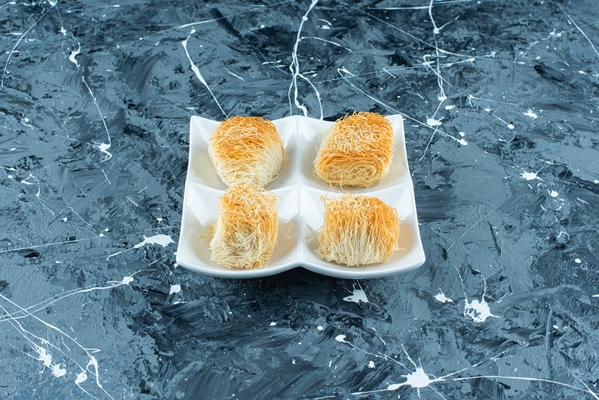 Печенье "Ангельские волосы" turkish dessert kadayif on a plate on the blue table - Печенье "Ангельские волосы"