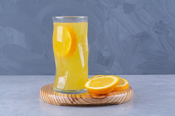 Лимонад с розмарином glass orange juice slice orange wooden plate marble table 1 - Лимонад с розмарином