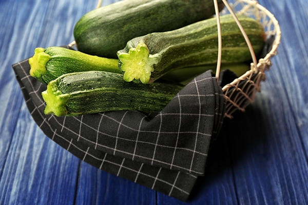 fresh zucchini napkin basket blue wooden background - Кабачки солёные