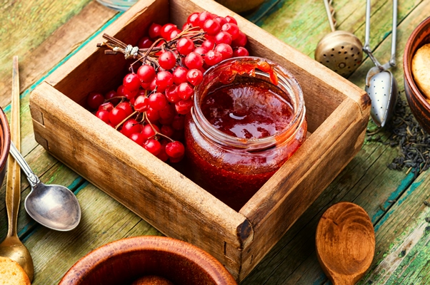 glass jar with jam fresh viburnum berries - Калина в сахаре