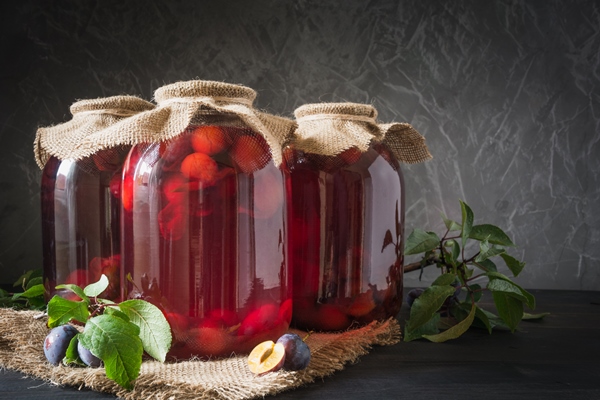 Сливовый компот без сахара three homemade canned plum compote large jars wooden board rustic style - Сливовый компот без сахара