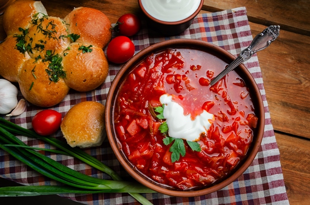 ukrainian national cuisine red borsch with donuts clay bowl wooden table - Борщ полтавский