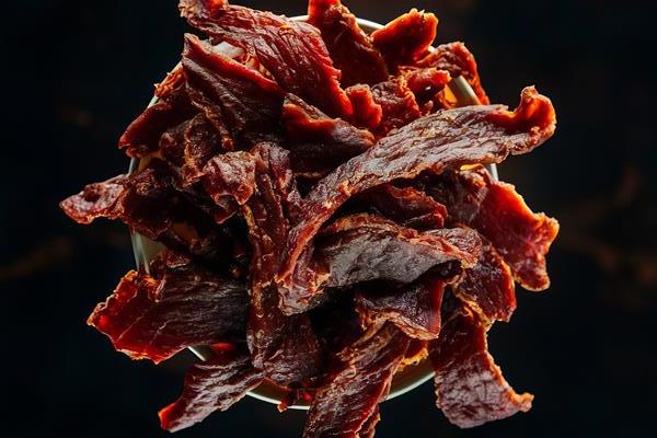 Джерки dried jerky beef meat dark background - Джерки