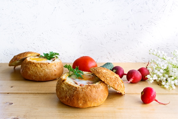 breakfast concept two baked eggs bun with fresh vegetables spring breakfast - Булочки с яйцом и сыром на завтрак
