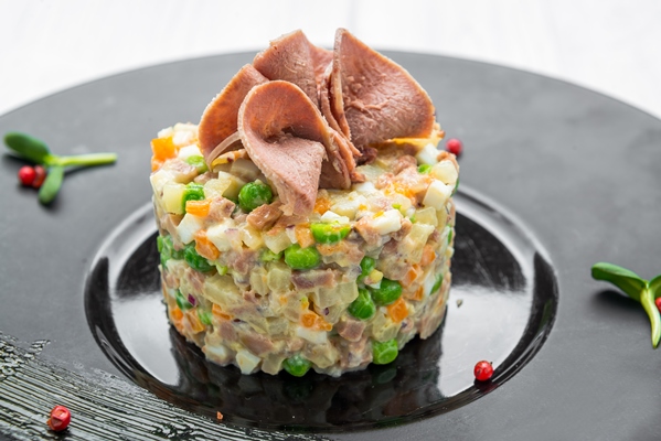 Салат "Оливье" с говяжьим языком healthy homemade russian traditional salad olivier ready eat plate close up - Салат "Оливье" с говяжьим языком
