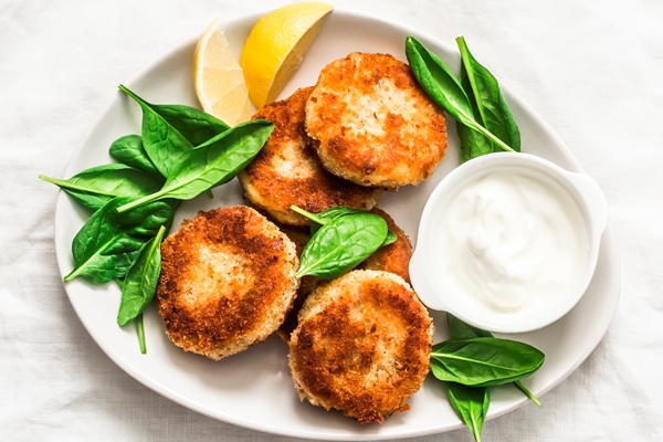 tuna potato patties served with spinach greek yogurt light background top view - Рыбные лепёшки по-ханты-мансийски