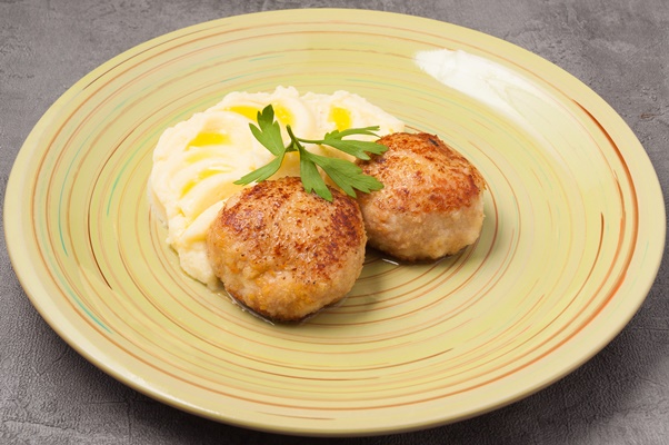 tasty puree with butter chicken cutlets decorated with parsley leaf - Котлеты из отварной рыбы