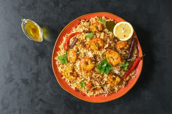 traditional indian biryani with shrimp tasty delicious prawns biryani top view - Плов с морепродуктами