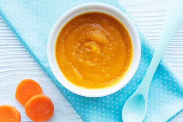 baby carrot mashed with spoon bowl baby food 1 - Морковное пюре для детского питания