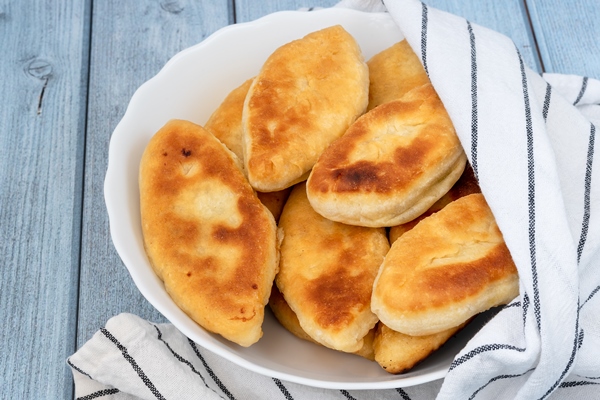 lush fried meat pies blue wooden background top view - Пирожки "Заволжские" (старинный рецепт)